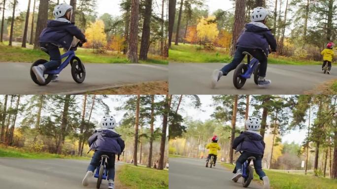 戴着头盔的孩子在公园骑平衡自行车