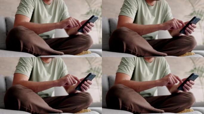 在社交媒体上，男人在家里用手机打字，在沙发上放松，在智能手机应用程序上进行移动聊天，在家里进行技术交