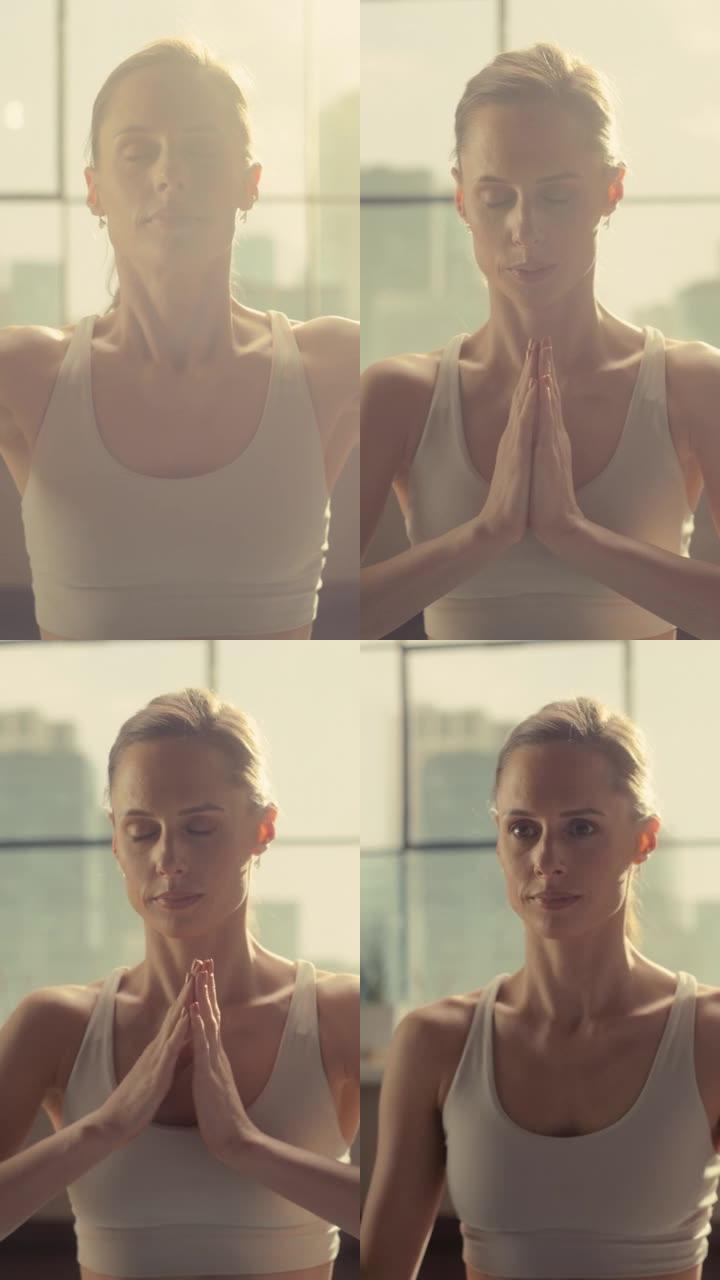 垂直肖像: 运动的年轻女性锻炼身体，早上在家里阳光明媚的房间里练习冥想。穿着运动服的美女在瑜伽垫上练