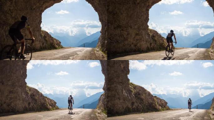 专注的年轻自行车手骑在山口上，穿过岩石隧道