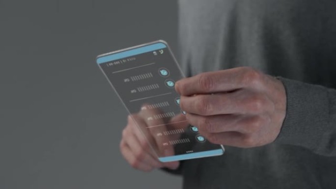 使用未来派HUD屏幕的人手，看起来像灰色背景上的手机
