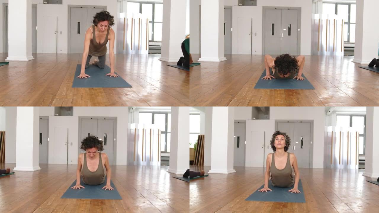 成熟的女人在瑜伽马上做伸展运动