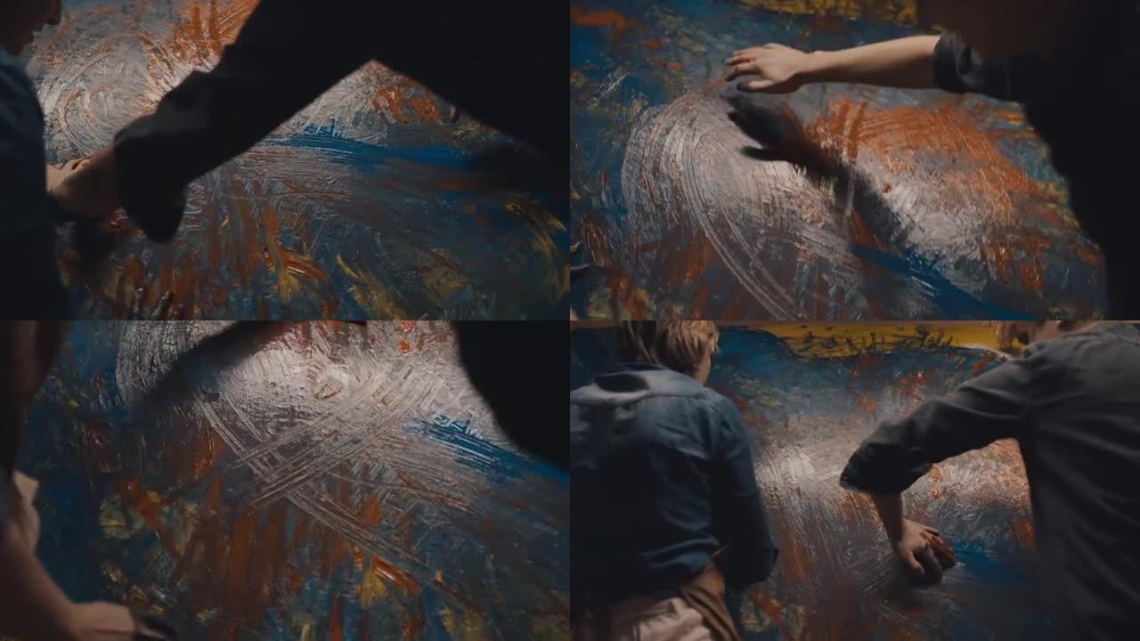 SLO MO才华横溢的艺术家夫妇用手在画布上画画