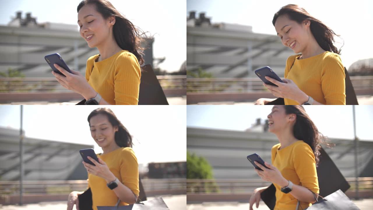 亚洲女性在现代办公室中使用智能手机