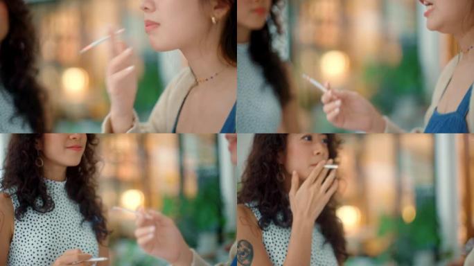 放松的女人和朋友一起吸烟。
