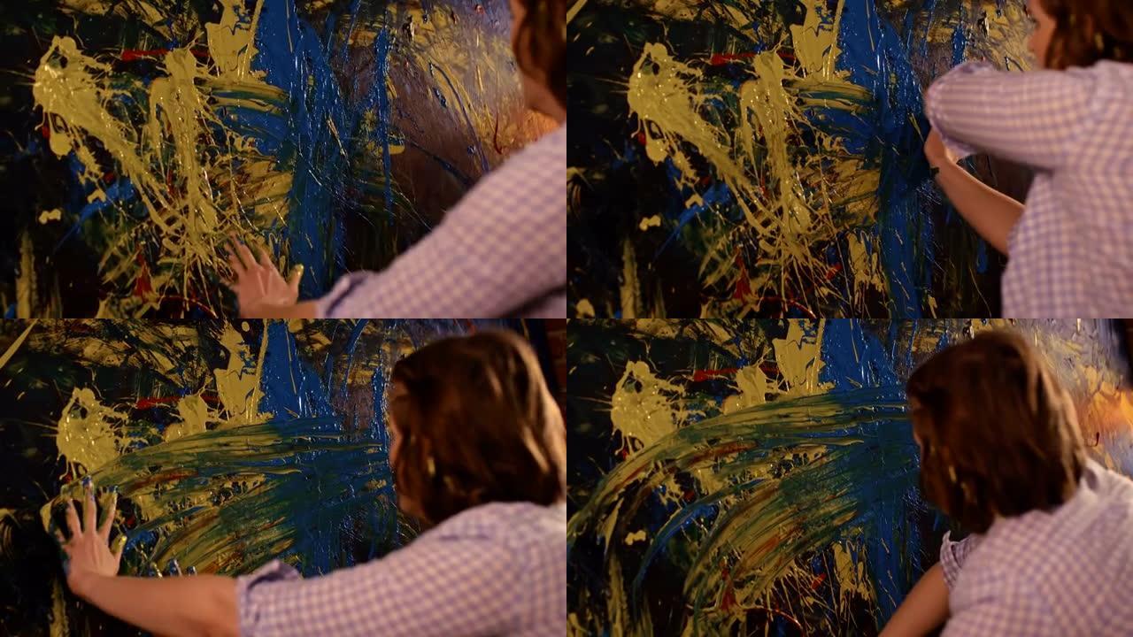 时间扭曲SLO MO才华横溢的女艺术家用手在画布上画画