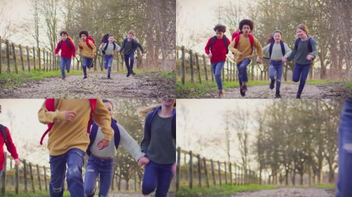 肖像儿童带着学校背包在户外沿着乡村轨道奔跑