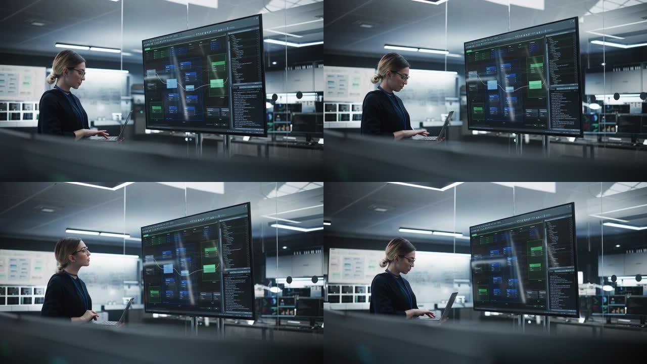 美丽的多民族首席软件工程师独自站在会议室中，使用大型电视显示屏查看由研发部门创建的计算机程序