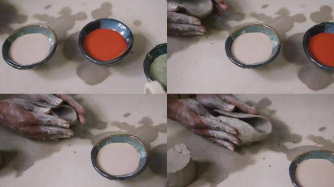在陶艺工作室制作陶罐的女性陶工的特写镜头