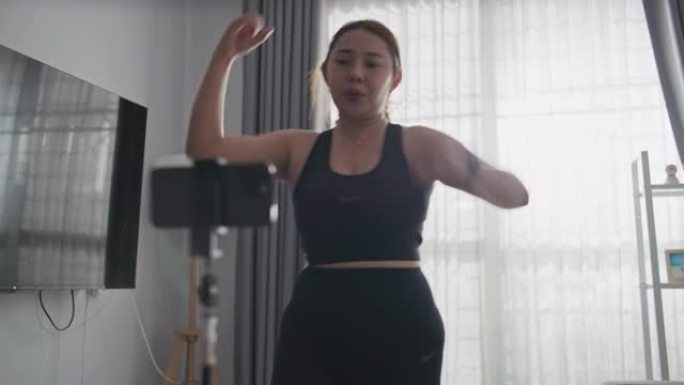 超重妇女在家里观看锻炼视频