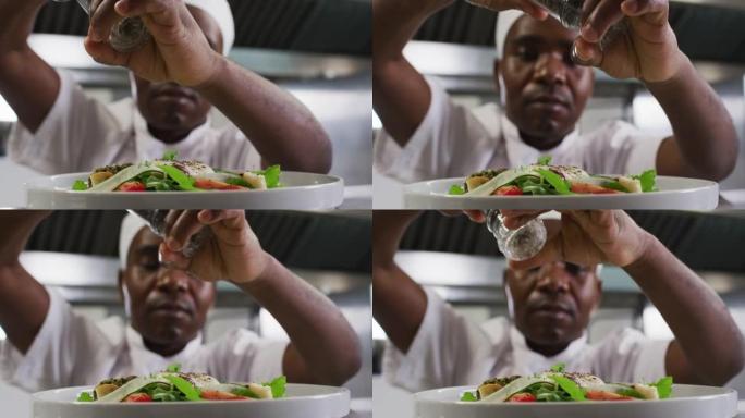 非裔美国男厨师在餐厅厨房装饰菜肴