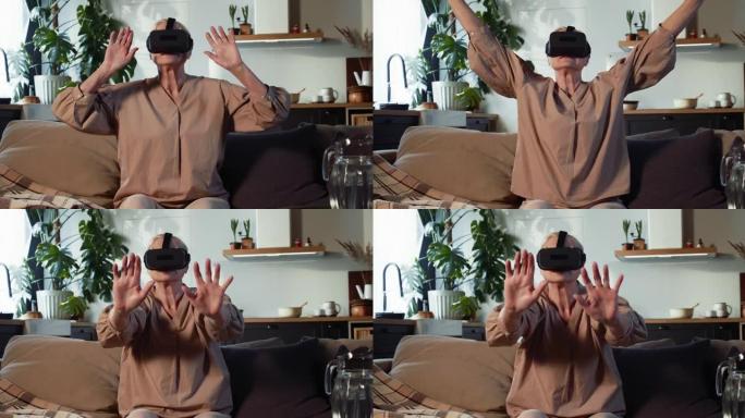 快乐60-65岁的高级女性戴着未来派虚拟现实耳机眼镜，在家中体验3D技术。