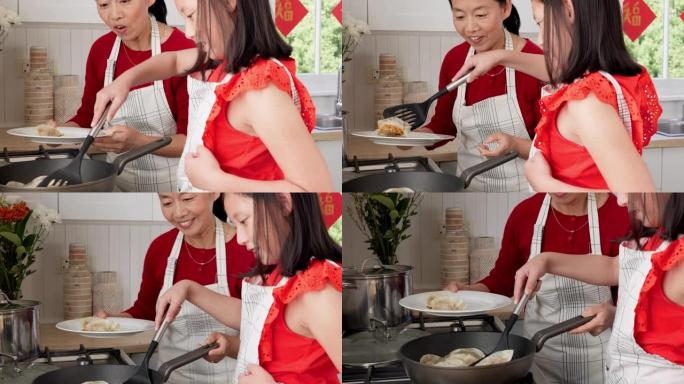 亚洲妈妈，女孩和在厨房一起做饭，在新加坡在家学习烹饪煎锅饺子，中餐和健康餐。儿童发展，母亲热爱教学，