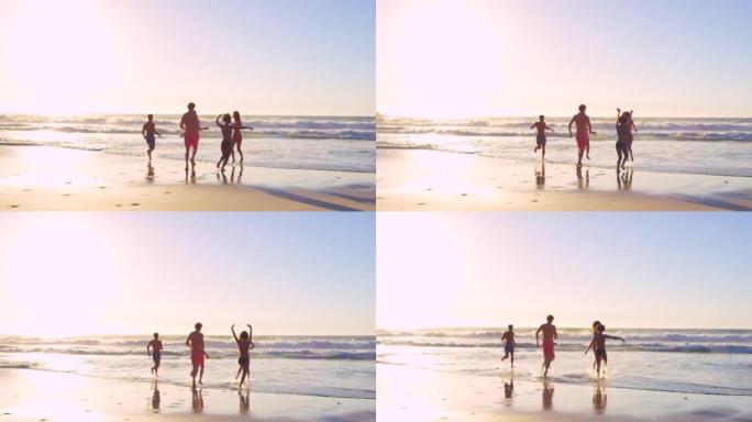 4k视频片段，一群无法识别的朋友在日落时奔向海洋