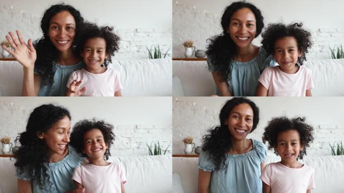 非洲妈妈和女儿微笑看着相机制作视频
