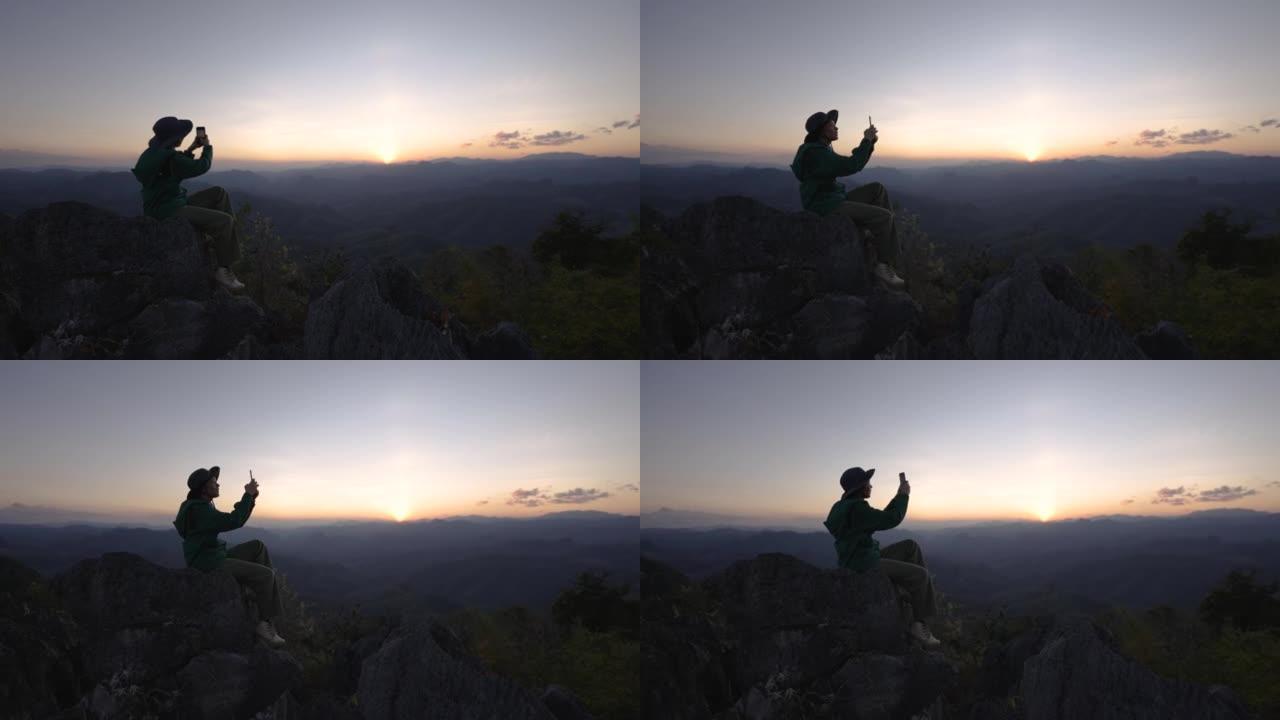 女人在山顶上徒步旅行，举手庆祝成功