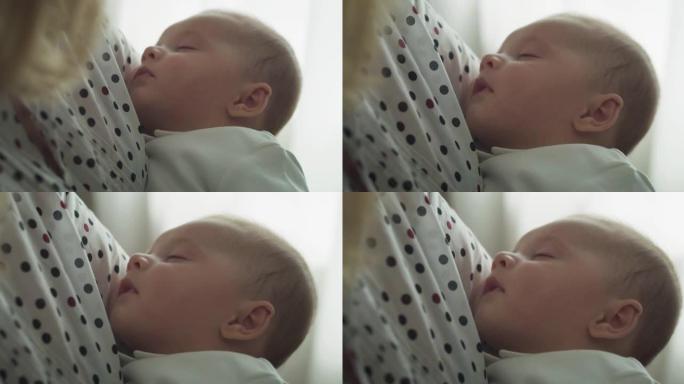 一位年轻的和平母亲的电影特写镜头拥抱着她蹒跚学步的男婴，同时在日光下睡在窗户上。甜梦、童年、生活、母