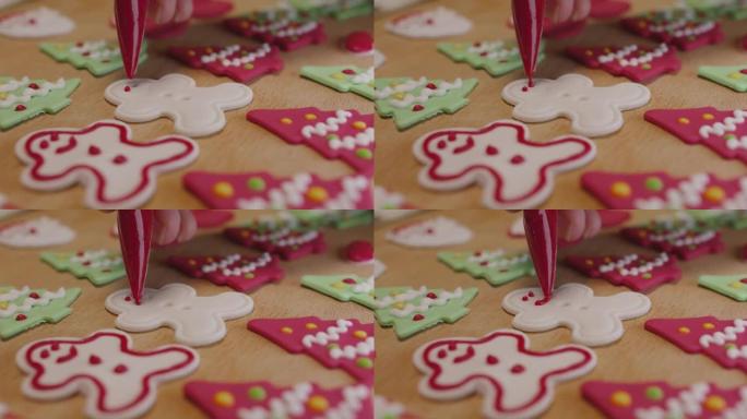 为圣诞礼物准备彩色姜人皇家糖衣饼干。