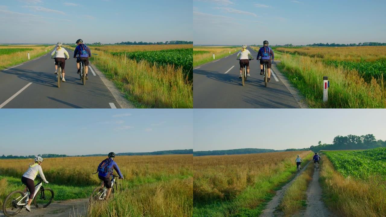 SLO MO夫妇在转弯到一条土路时在路上骑自行车