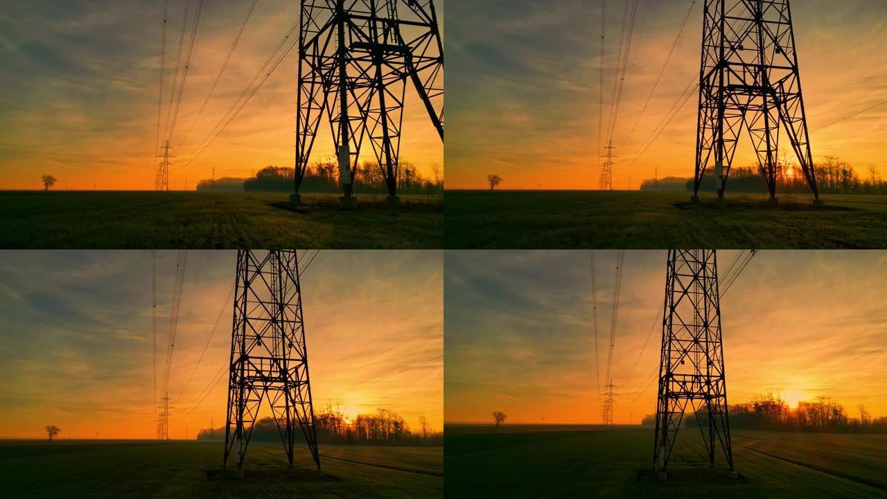 日落时田园诗般的乡村的电塔和电线