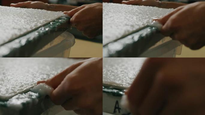 工匠造纸大师的慢动作特写正在车间生产高质量的手工纸。以8K拍摄。手工制作的概念，高品质，工匠，意大利