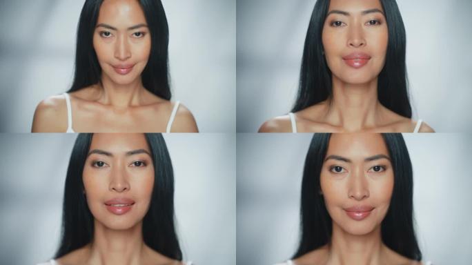 美丽的亚洲女人看着相机，微笑着。女性享受她的美丽、高度自尊、健康。天然化妆品护肤品。以孤立的背景聚焦