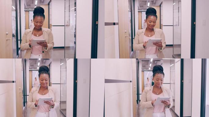 4k视频片段，一名年轻的女商人在走过现代办公室时使用数字平板电脑