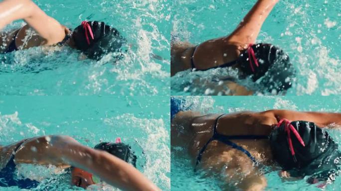 美丽的女游泳者使用前爬行，在游泳池自由泳。专业运动员训练赢得冠军。电影慢动作，颜色，时尚特写，高角度