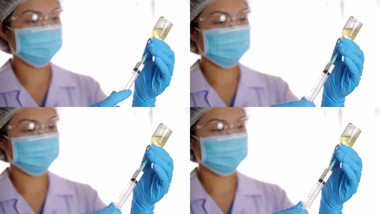 医生戴着手套用注射液体、疫苗填充注射器