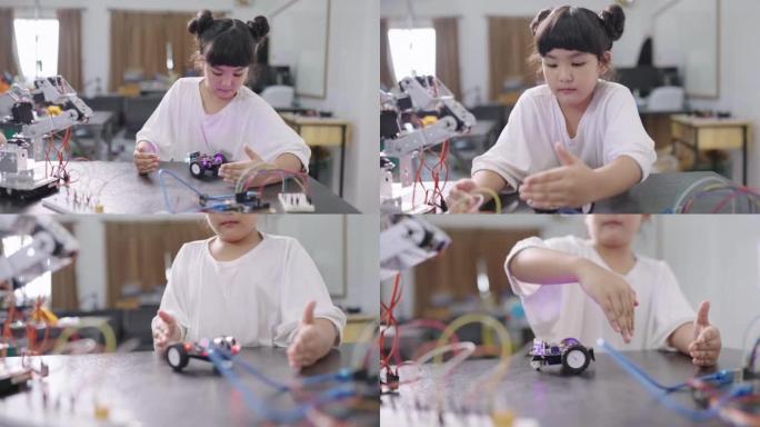 一个女孩在实验室的桌子上欢快地玩耍和运行她的机器人汽车。STEM教育。