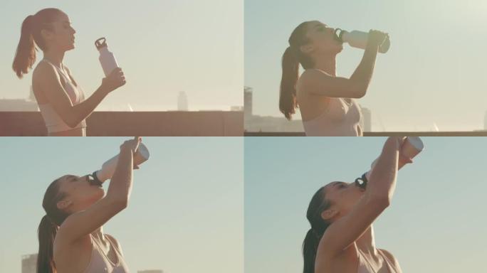 4k视频片段，一名年轻女子在跑步时喝了一瓶水
