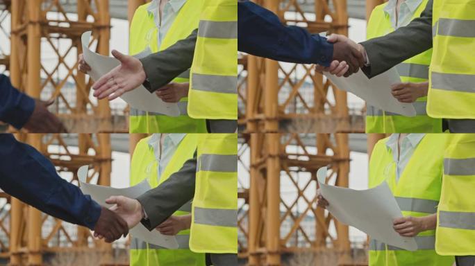 面目全非的建筑工地工人握手