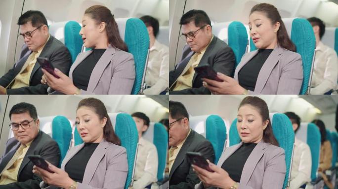 亚洲企业家妇女在等待飞行时使用电话工作。