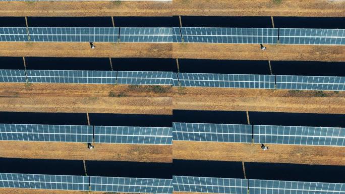 一名男子正俯视图中穿过太阳能发电厂