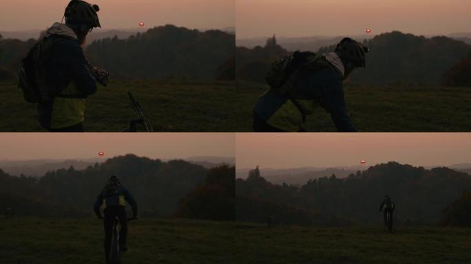 SLO MO MTB骑自行车的人在黄昏时在乡下骑车时检查时间