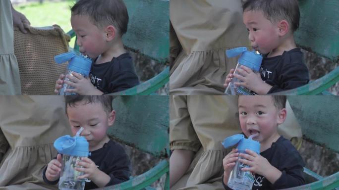 亚洲男孩玩耍后喝水