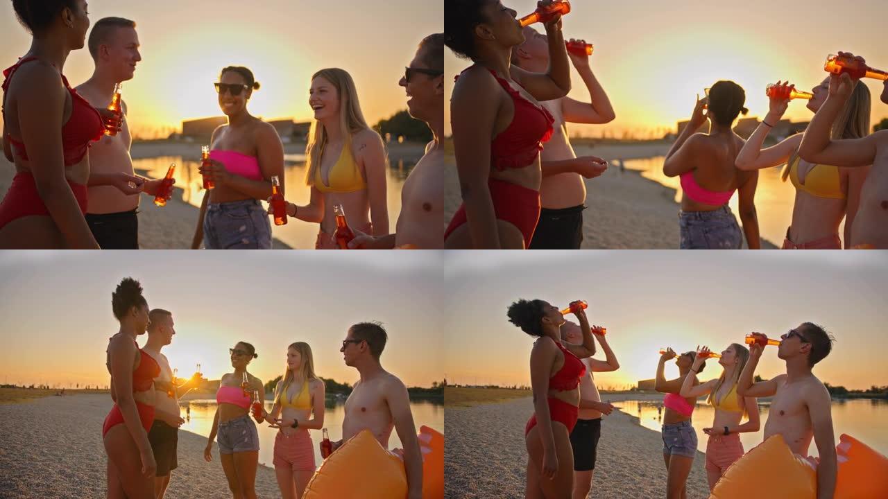 SLO MO一群年轻朋友在日落时在海滩上用冷饮敬酒