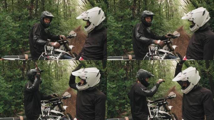 欢快的摩托车手在森林中击掌