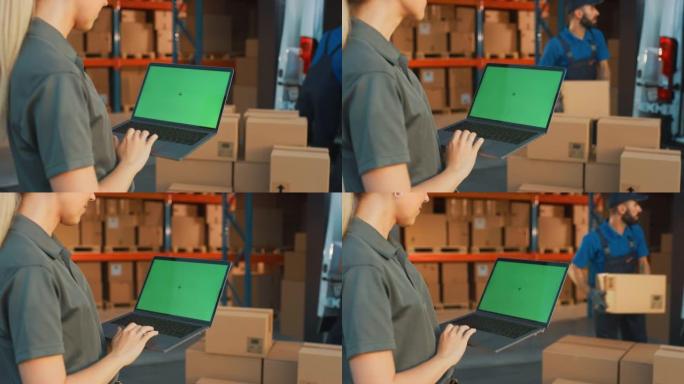 女经理使用绿屏色度键笔记本电脑。在后台仓库零售中心用纸箱，电子商务在线订单，食品，药品，产品供应。超