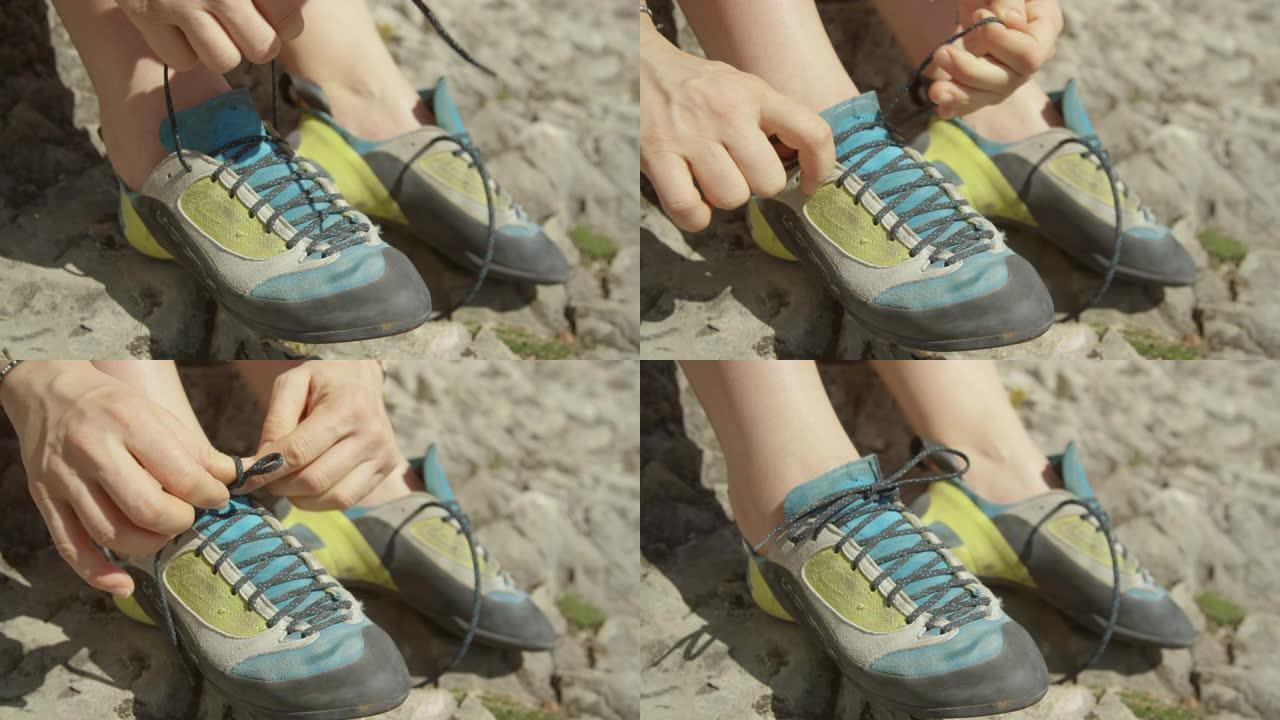 特写: 攀岩旅行中的女人通过系鞋带来准备上升。