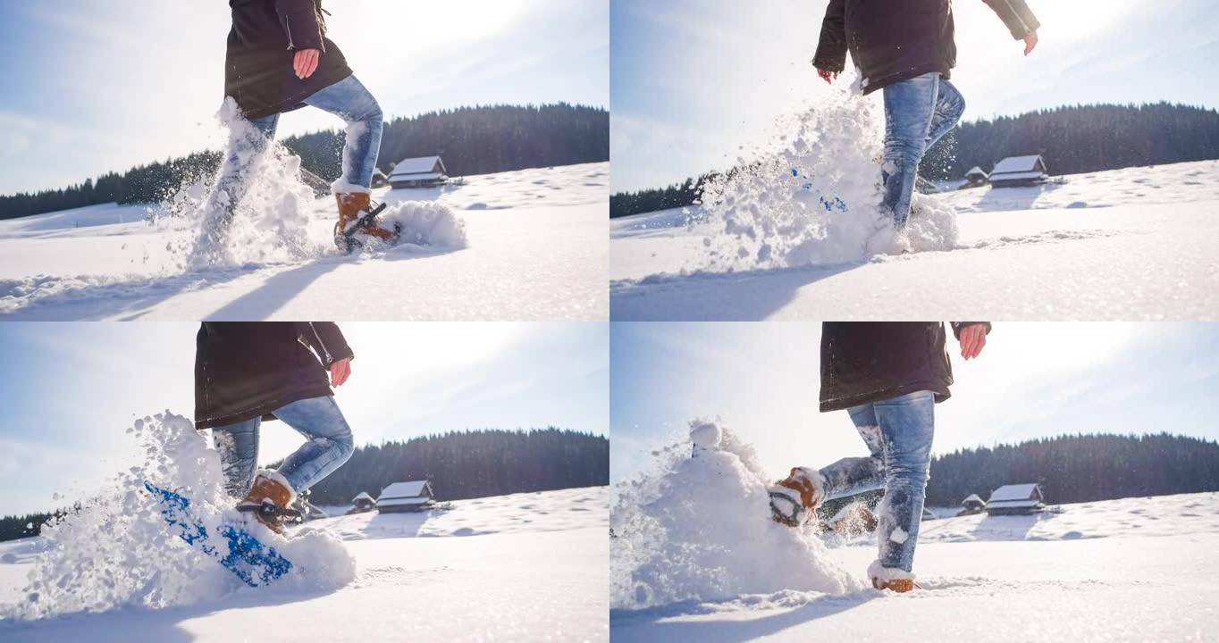 用绑在脚上的雪鞋在新鲜落下的粉末雪上徒步旅行