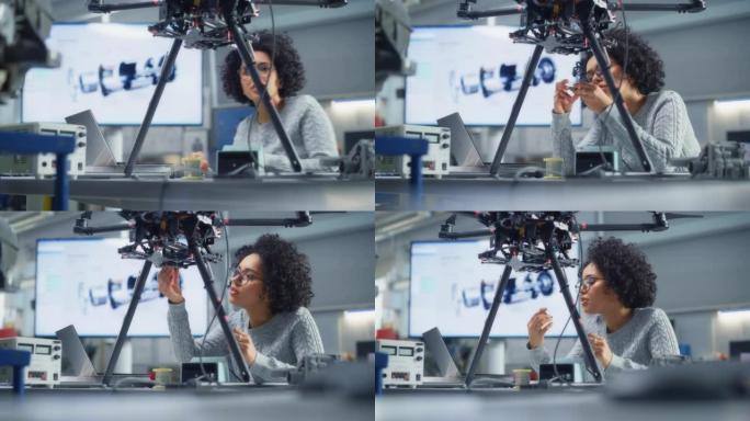 集中的女性黑人工程师在研究中心实验室开发无人机时编写代码。无人机设计理念的突破。肖像视图