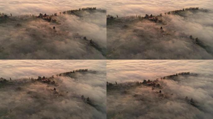 空中晨雾环绕着教堂和山顶上的村庄