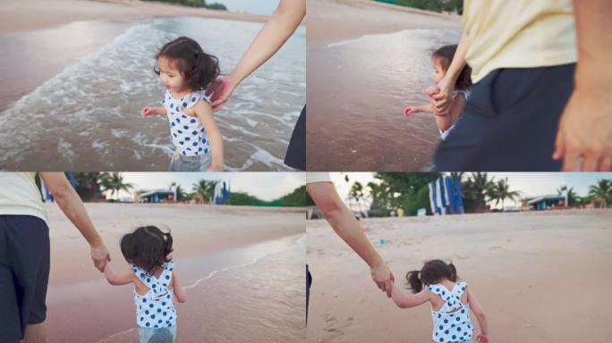 亚洲父亲与可爱的女儿在海滩度假时玩耍和散步