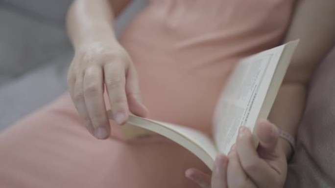 怀孕的亚洲妇女看书休息时间与婴儿