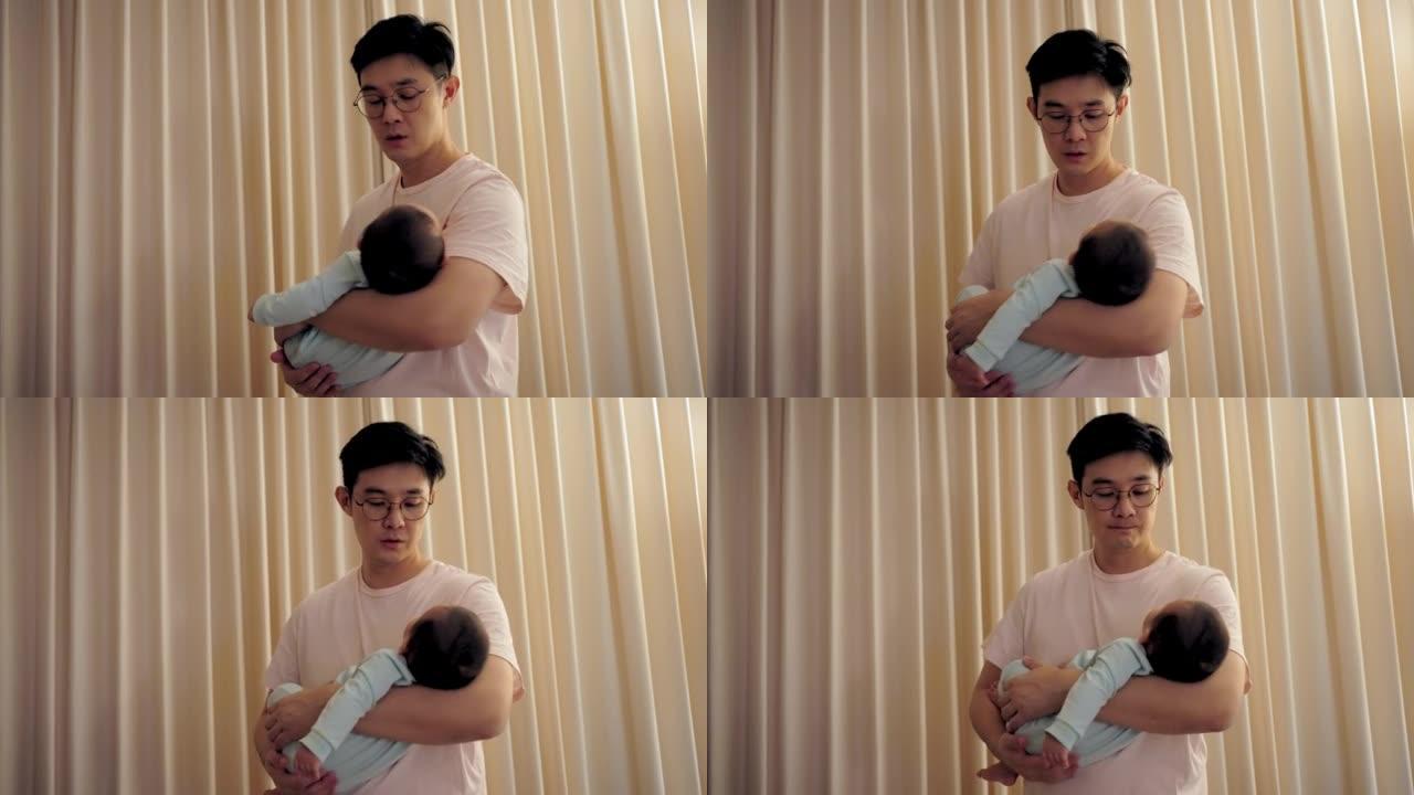 父亲怀里抱着可爱的新生婴儿。他试图让婴儿晚上睡觉。为人父母，父亲的概念