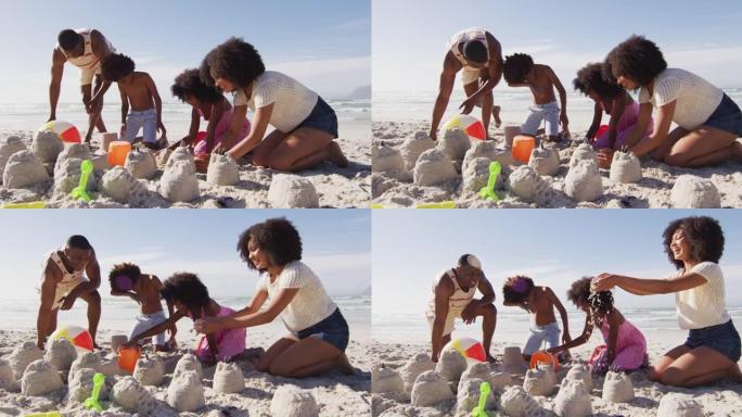 非裔美国父母和他们的孩子在沙滩上玩沙子