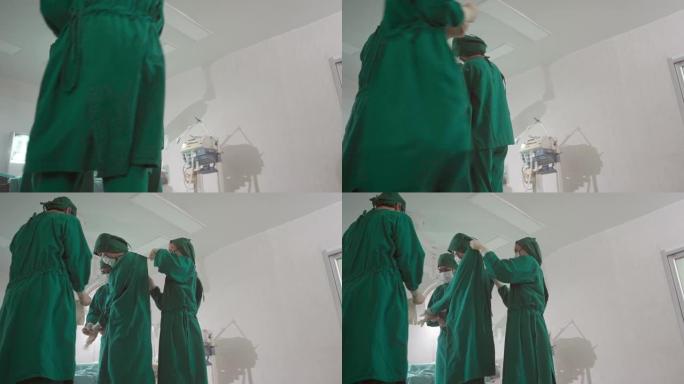 4K UHD Dolly右: 外科医生在手术前穿上手术擦洗布和手术手套。医院医疗保健概念。