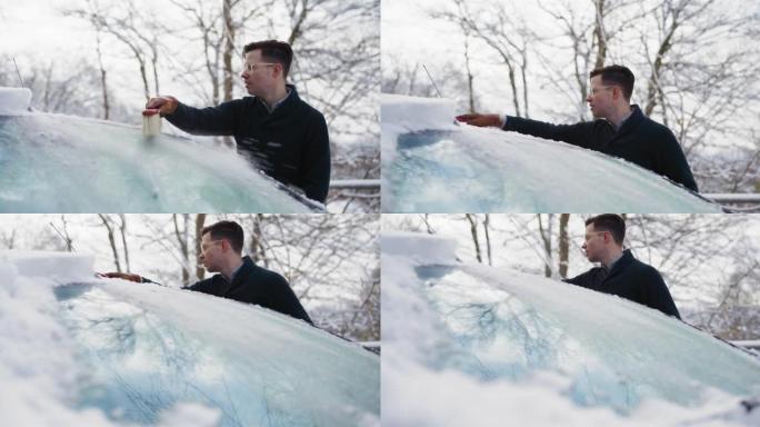 从汽车上刷雪清理汽车上的积雪一个男人在扫