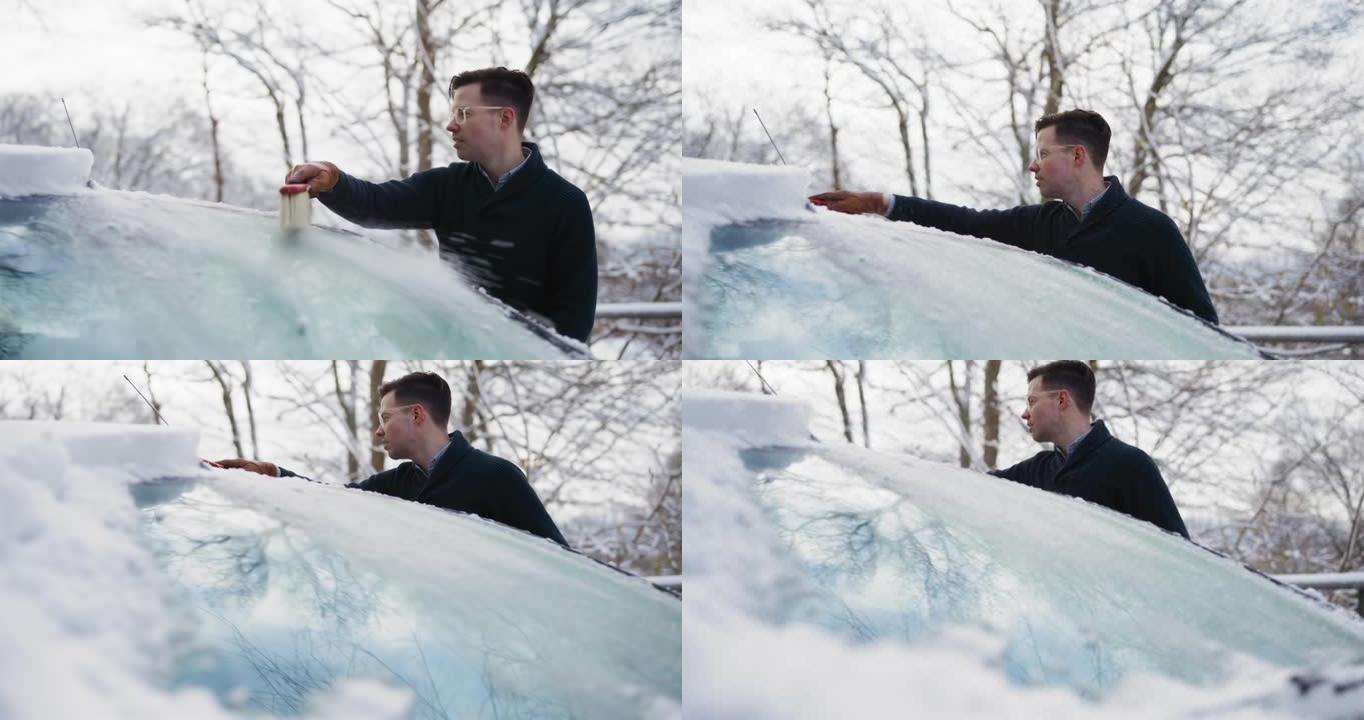 从汽车上刷雪清理汽车上的积雪一个男人在扫
